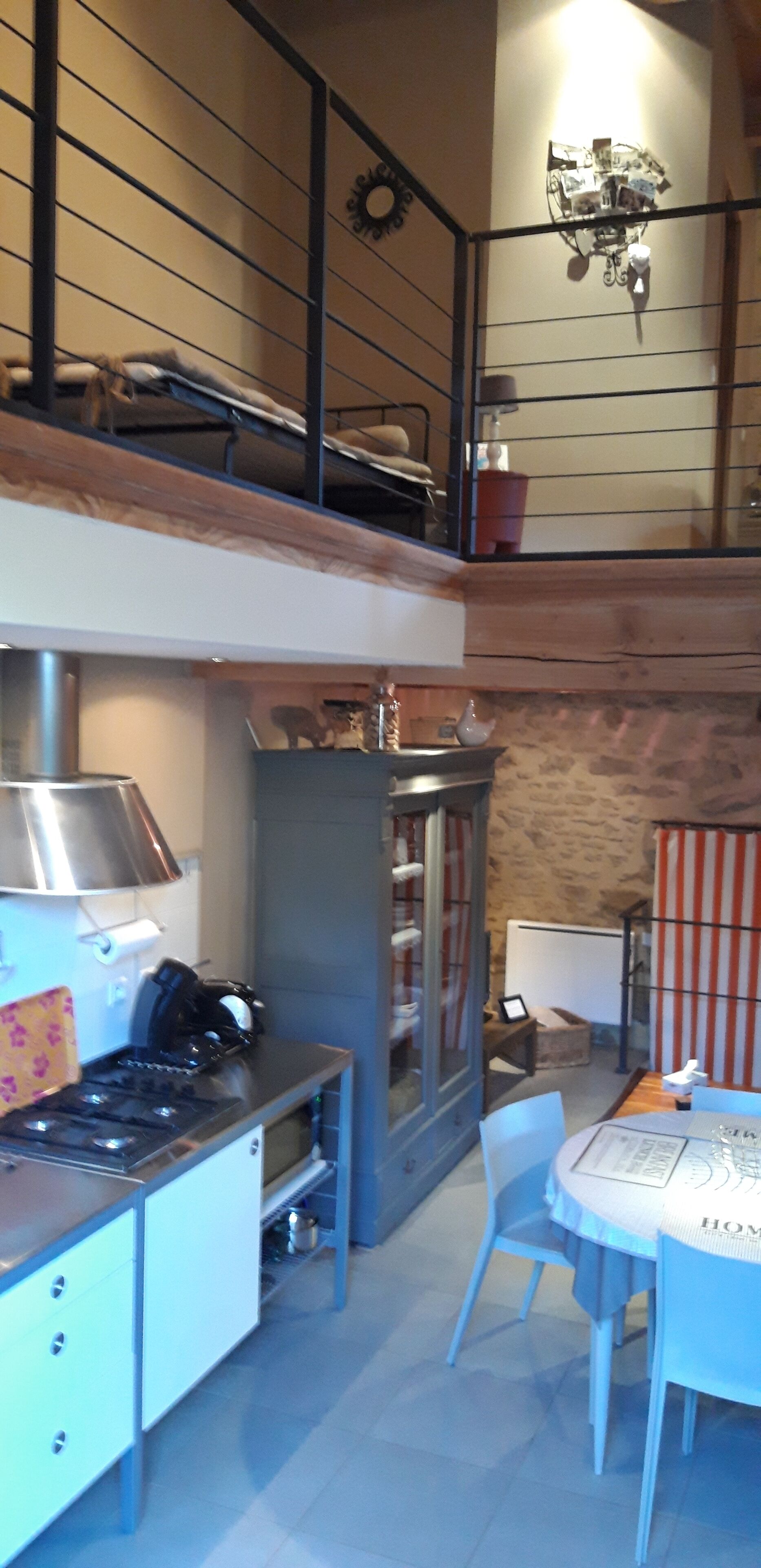 A kitchen with a stove, oven, and a dining area with a table and chairs.