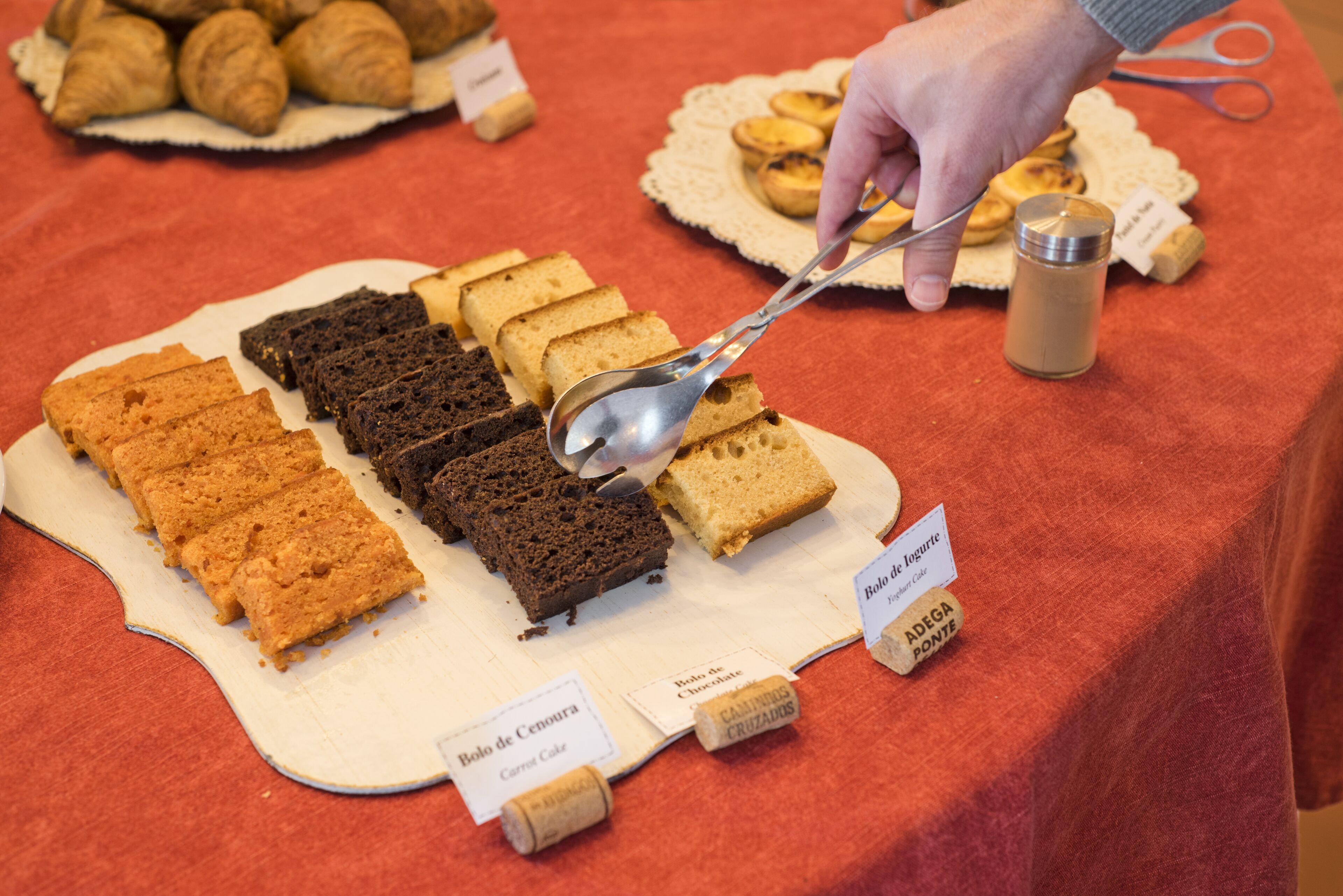 A selection of baked goods on a table with labels indicating different types of bread and pastries.
