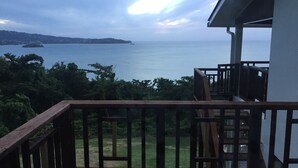 A wooden deck with a view of the sea and a distant island. - Tropical, Romantic and  Chic at Marisule Villa (Gros Islet)