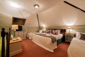 A bedroom with a large bed, a desk, a chair, a television, and a painting on the wall. - Cambridge Bed and Breakfast (Cambridge)