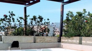 A hot tub with wooden steps leading up to it, surrounded by a covered patio area.