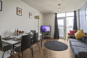 Family Apartment, Multiple Beds | Living area | 42-inch Smart TV with digital channels, TV, Netflix