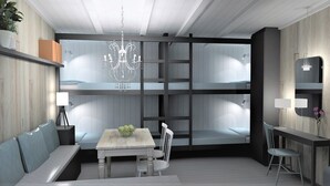 A modern interior with a dining area, a bench, a table, and a chandelier.