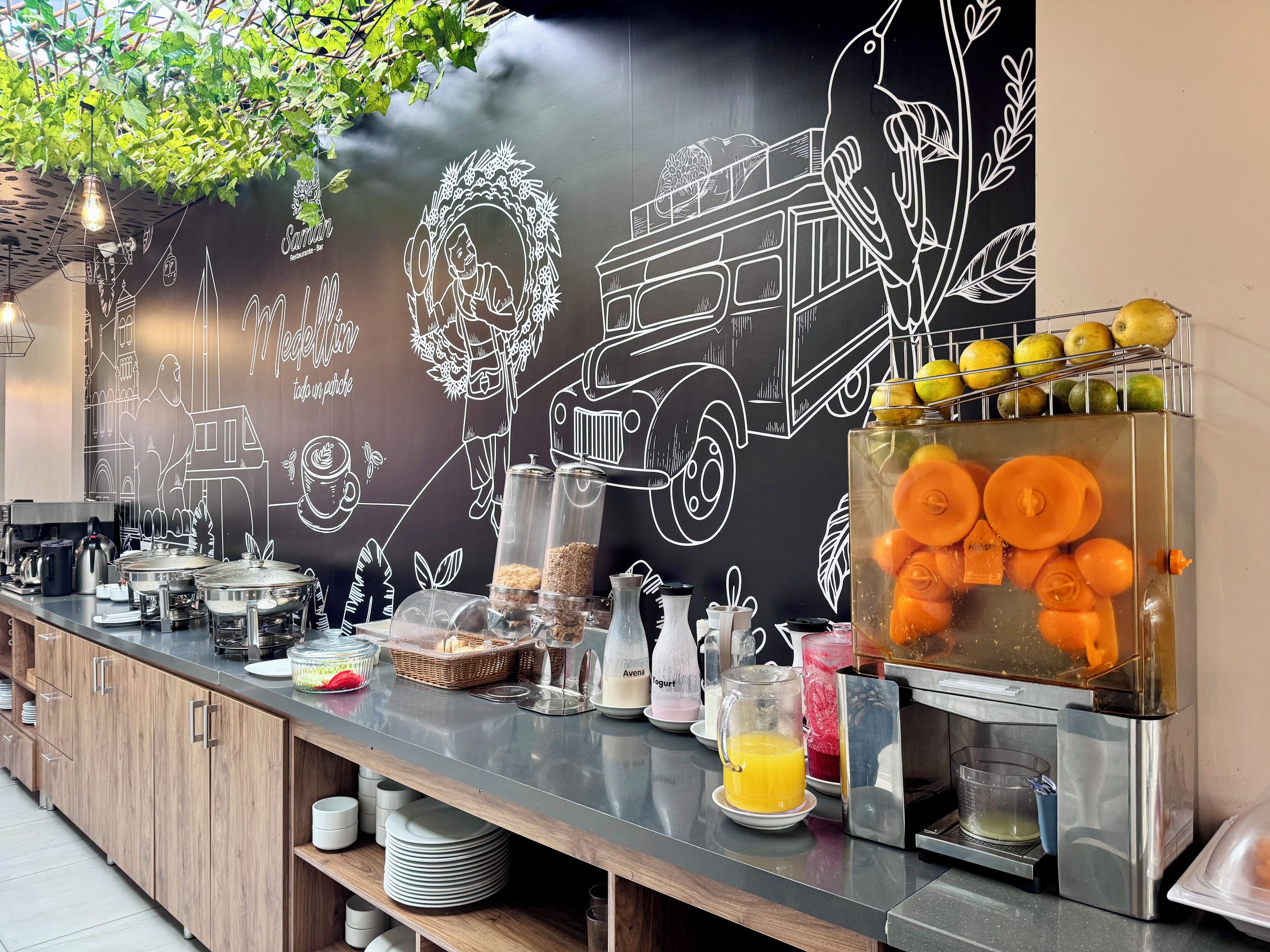 A breakfast bar with various food items and a chalkboard wall with drawings.