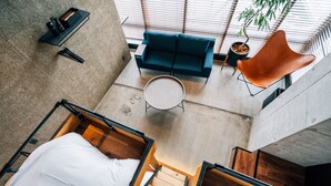 A modern interior with a sofa, a chair, and a small table. - ZONK HOTEL NAKASU-DEAIBASHI (Fukuoka)