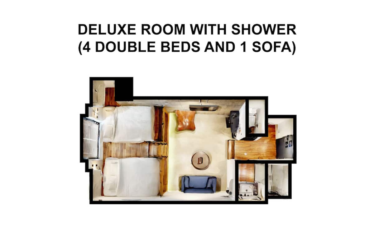 A deluxe room with a shower, featuring 4 double beds and 1 sofa.