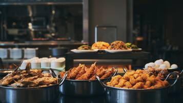 A buffet with various food items including fried seafood and other dishes.