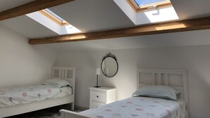 A bedroom with two beds, a nightstand, a mirror, and skylights. - Delightful family friendly villa with new private & heated pool   (Cébazan)