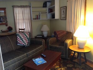 Relax in this inviting living room with a sofa, armchair, and coffee table.