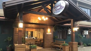 A wooden structure with a sign reading "Pousada Encantos de Gramado." - Pousada Encantos de Gramado (Gramado)