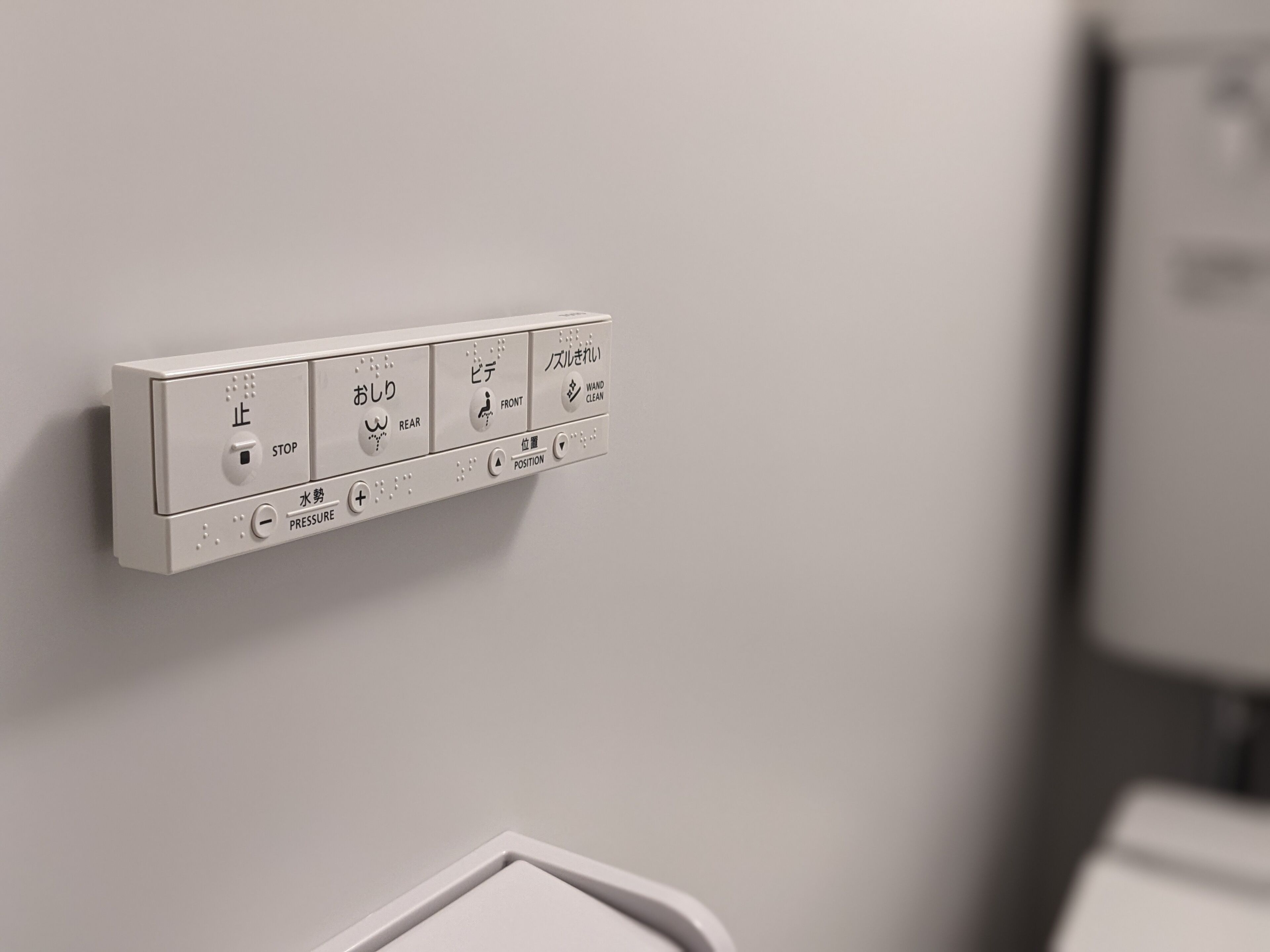 A wall-mounted control panel with stop, rear, front, and position buttons, and a water tap.