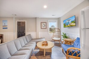 A living room with a sofa, armchair, and coffee table.