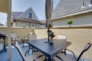 Enjoy al fresco dining on the patio, which features a grill and comfortable seating.