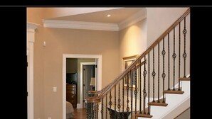 A staircase with wooden steps and black balusters, leading to an upper floor. - Beautiful -Spacious Home @ Lake Lanier (Flowery Branch)