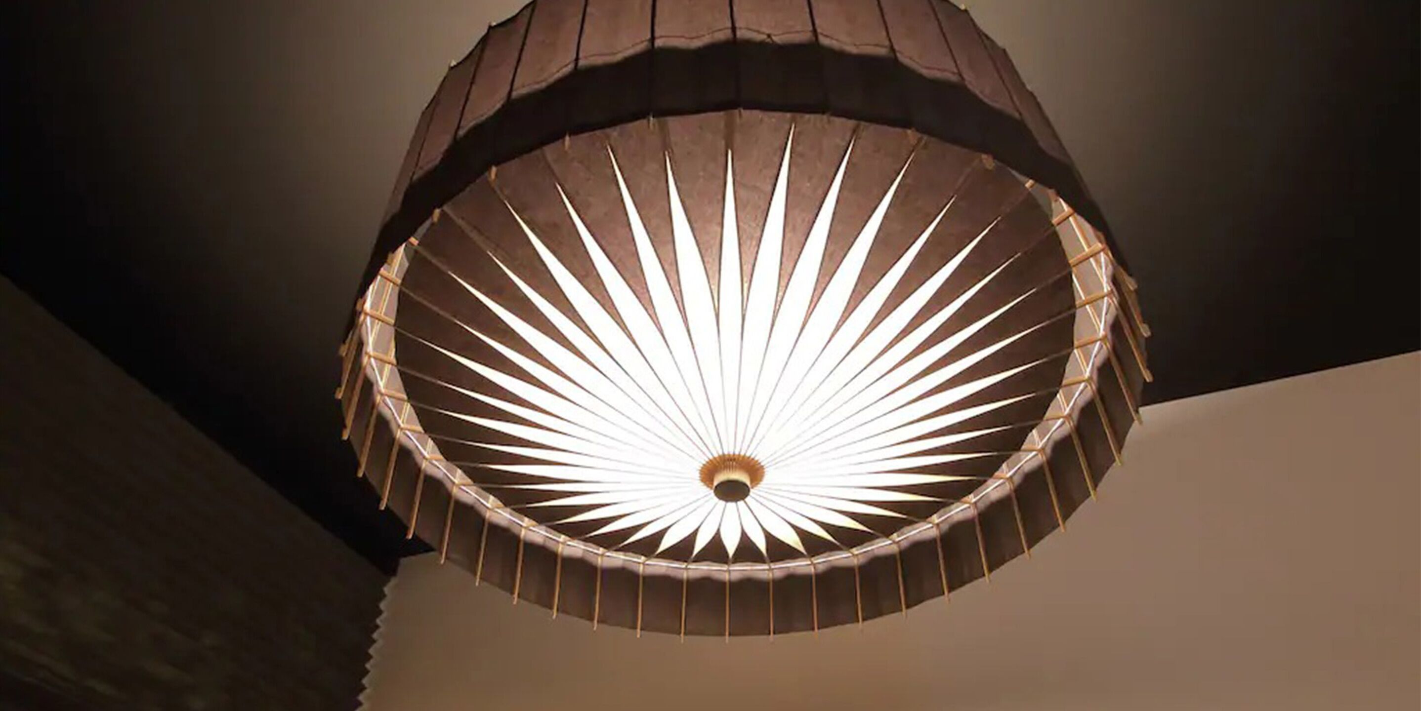 A ceiling with a circular, radiating light fixture.