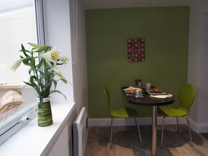 Enjoy meals in this cozy dining area with a round table and two chairs.