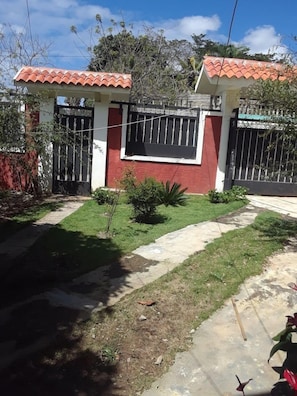 Welcome to a charming home with a beautifully landscaped yard and an entrance.