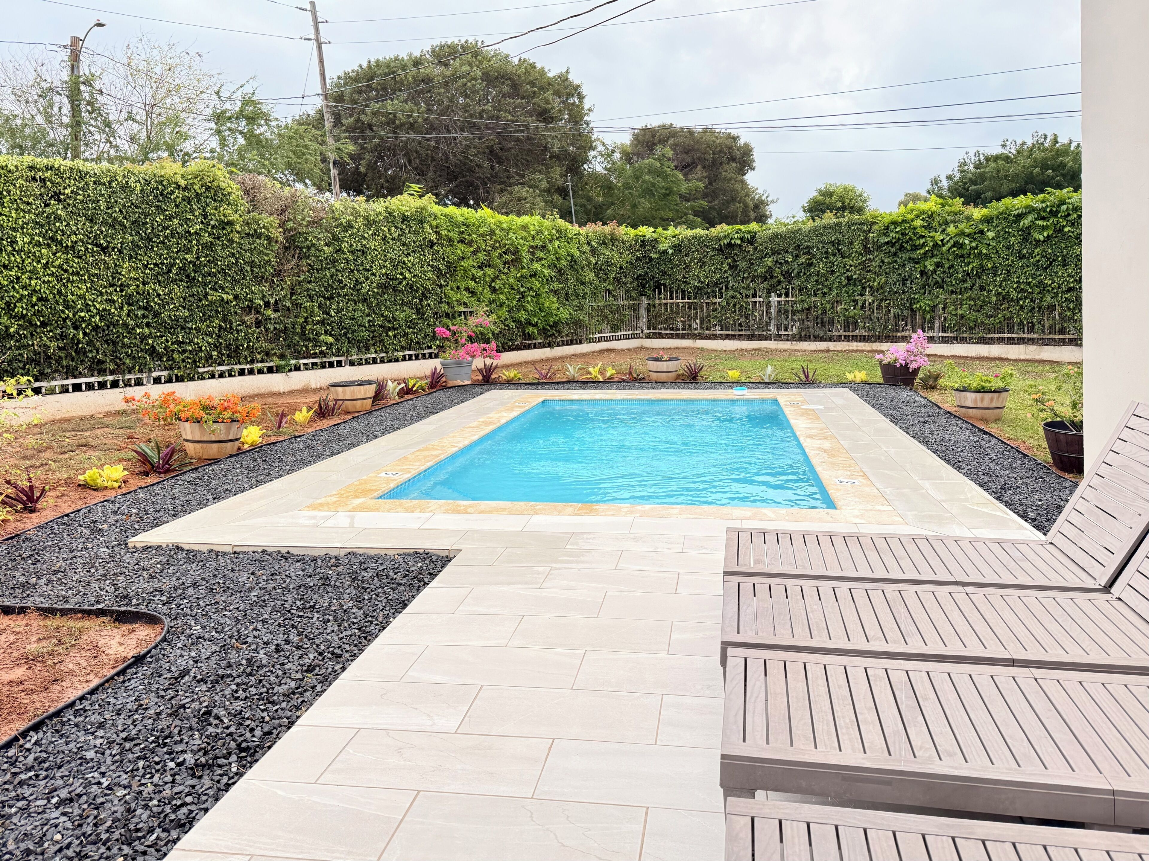 Private swimming pools with lounge chairs.