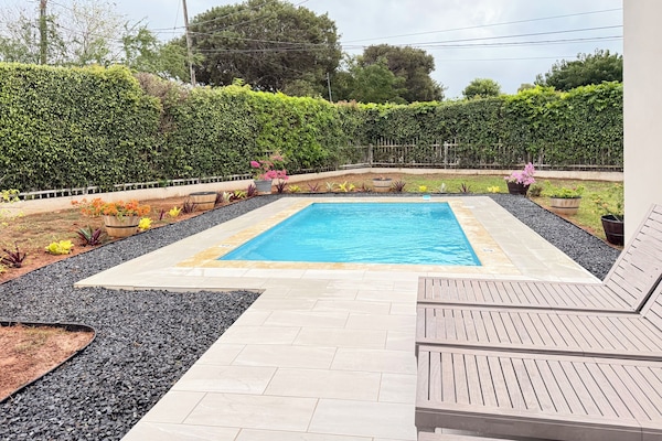 Private swimming pools with lounge chairs.