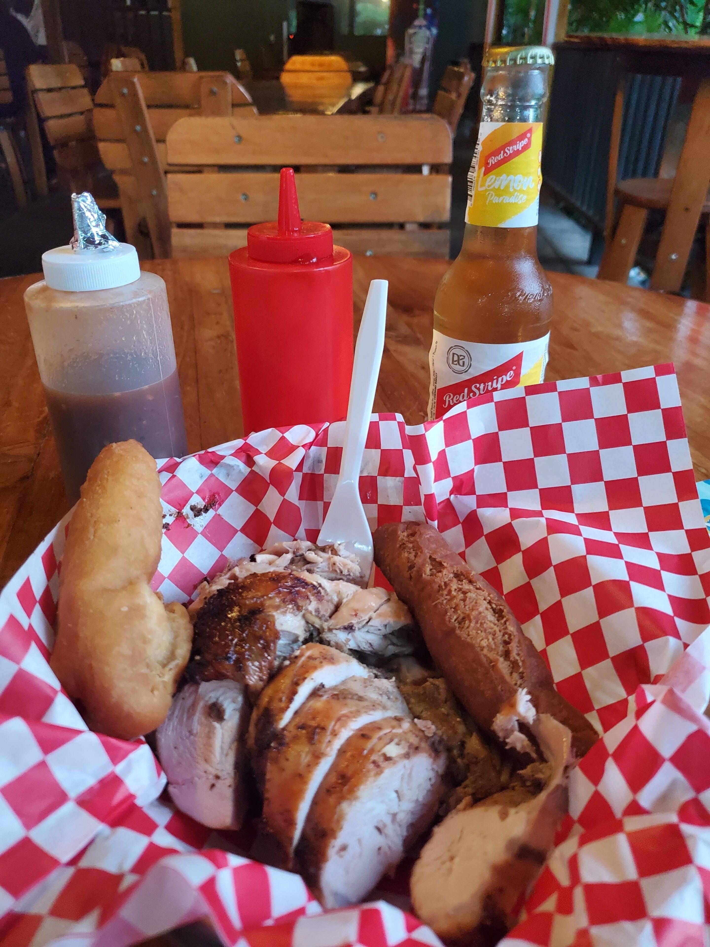 A meal consisting of sliced meat, bread, and condiments on a table.