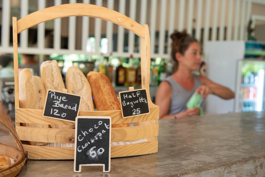 A bakery display with bread types and prices.