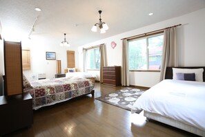 Relax in this traditional room with a large bed, a smaller bed, and a cozy seating area.
