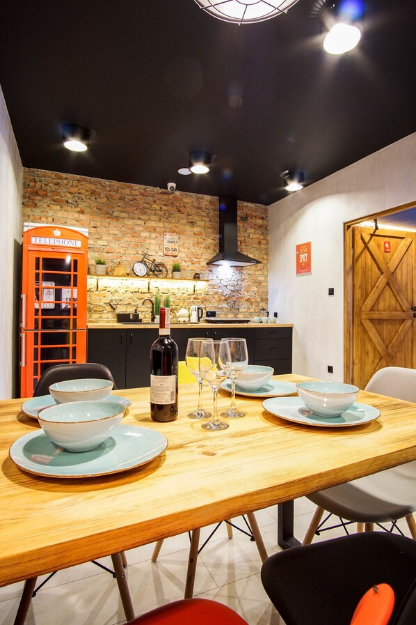 A dining area with a brick wall, a telephone booth, and a wooden door.