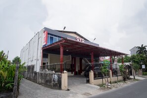 A building with a red roof and a sign that reads "OYO". - Hotel O Titipapan Residence (Medan)