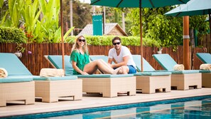 A poolside area with lounge chairs and a swimming pool.