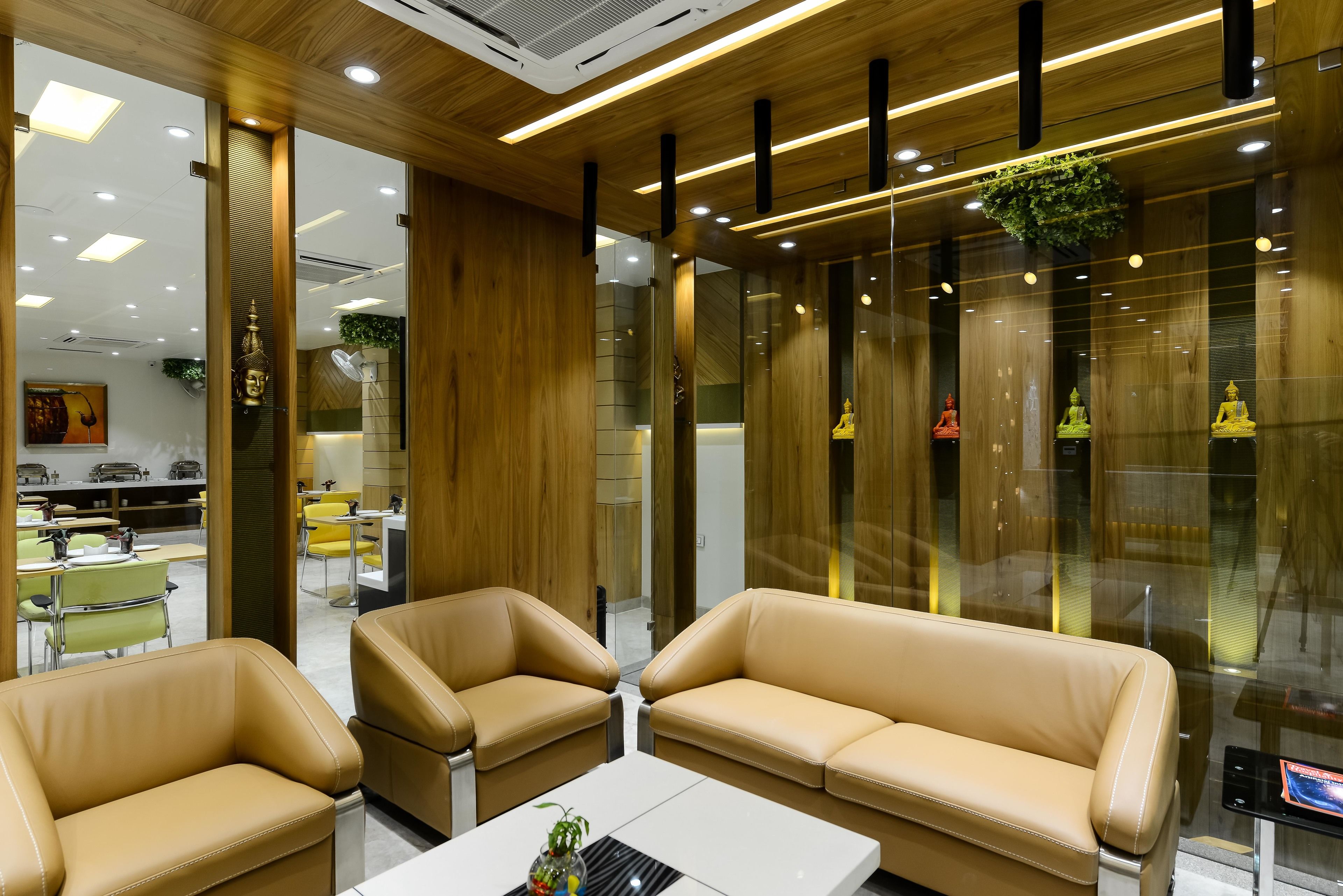 A modern interior with leather sofas, a white coffee table, and wooden accents.