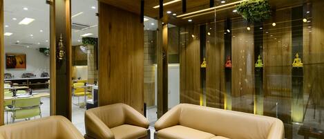 A modern interior with leather sofas, a white coffee table, and wooden accents.