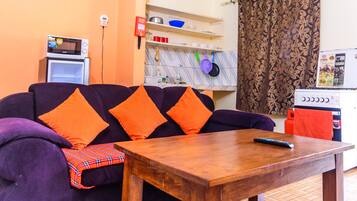 Deluxe Apartment, 1 Bedroom, Garden View | Living area | 32-inch flat-screen TV with cable channels, LED TV, iPad