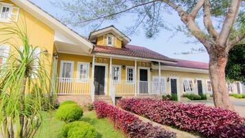 Stunning two-story building with a charming front porch and beautifully maintained grounds.