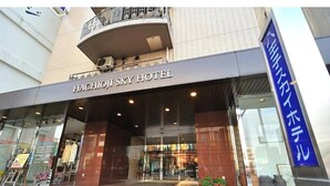 The exterior of the Hachijo Sky Hotel with a modern facade, large glass windows, and a visible entrance. - Hachioji Sky Hotel (Hachioji)