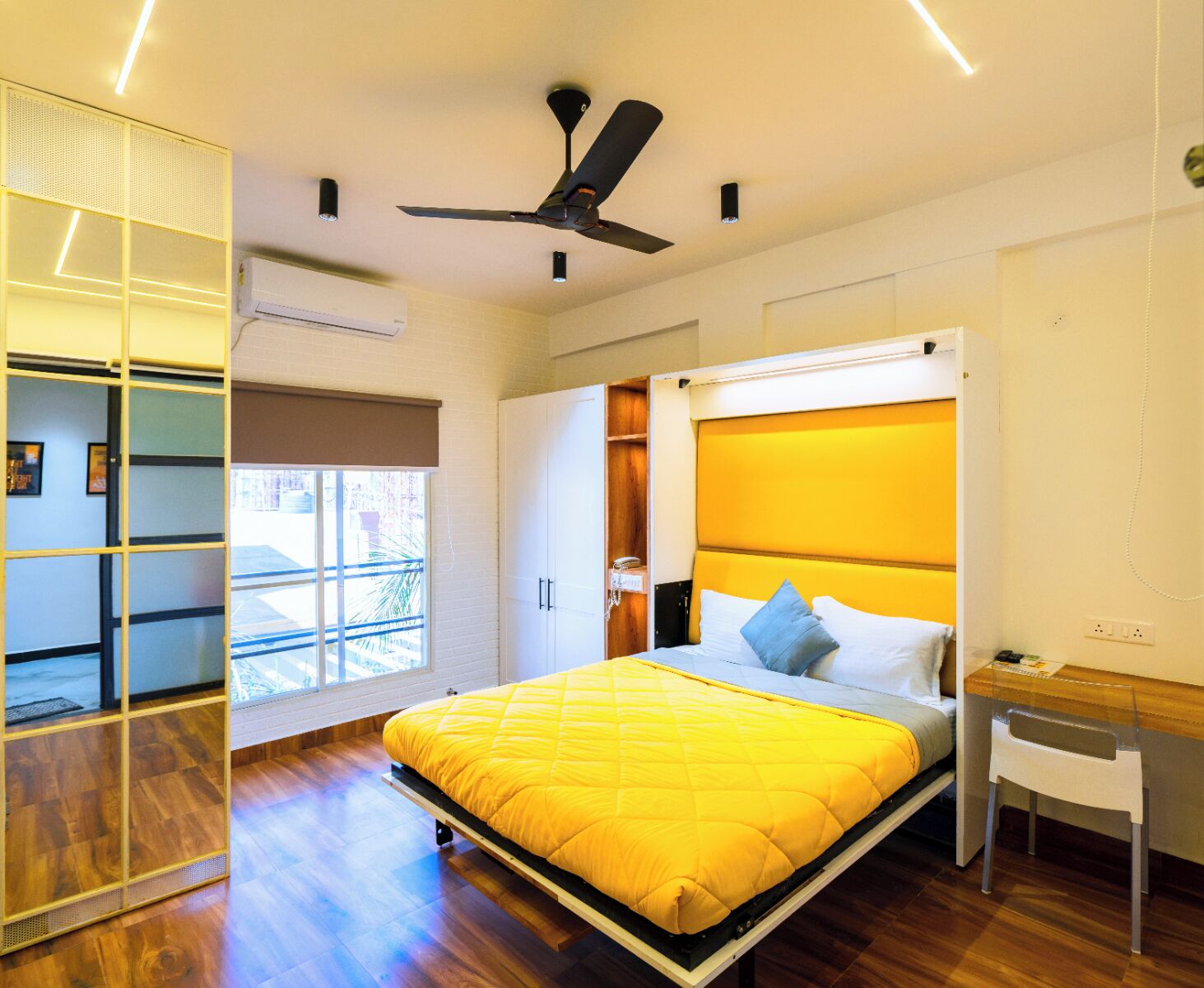 A modern bedroom with a bed, a ceiling fan, and a window.