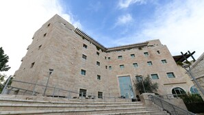 A multi-story building with a stone facade, a large central entrance, and a staircase leading to the entrance. - HI Agron Jerusalem Hostel (Jerusalem)