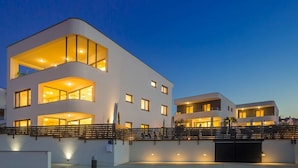 A modern multi-story building with balconies, large windows, and a gated entrance. - JAZZ at Rova Apartment Sol (Malinska-Dubasnica)