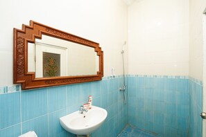 A bathroom with a sink, mirror, and shower. - Hotel O Mojokerto Guesthouse (Mojokerto)