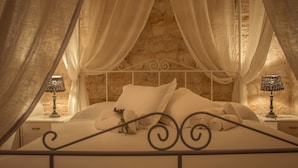A bed with white linens, a canopy, and two bedside lamps. - TD Casale Terranova Stone Farmhouse with Pool (Monopoli)