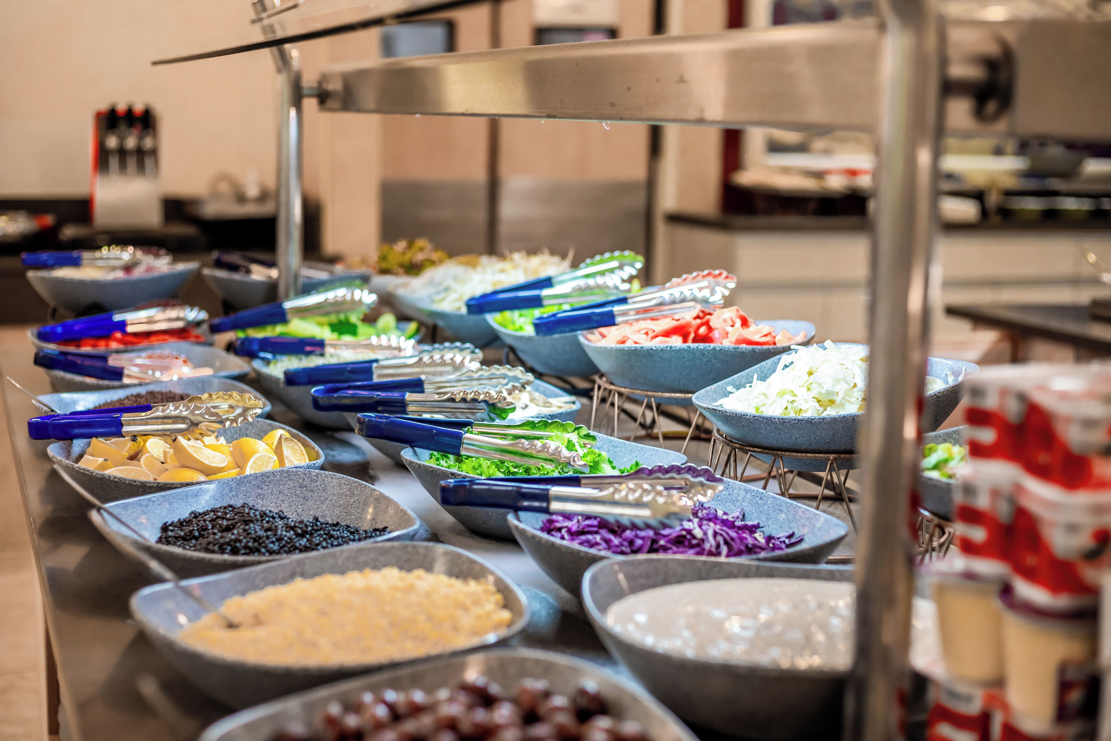 A buffet with various food items in bowls, arranged on a table.
