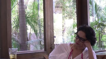 Relax in a peaceful space with a view of lush tropical vegetation through large windows.