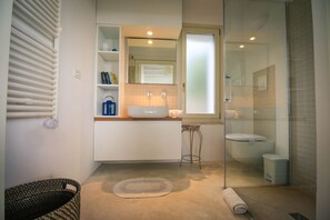 A modern bathroom with a glass shower enclosure, a white sink, and a built-in mirror. - TD Trulli di Bouganville w/ Large Amazing Pool (Monopoli)