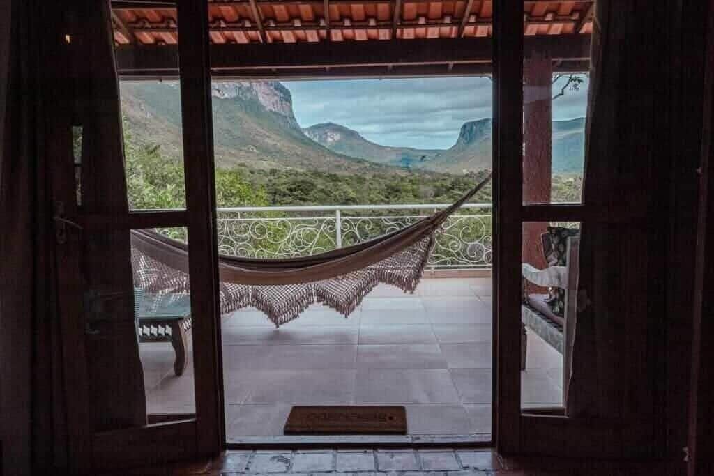 A room with a view of a mountainous landscape through large windows.