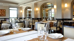 A restaurant with multiple tables set for dining, featuring white tablecloths and glassware. - Domus Park Hotel & SPA (Frascati)