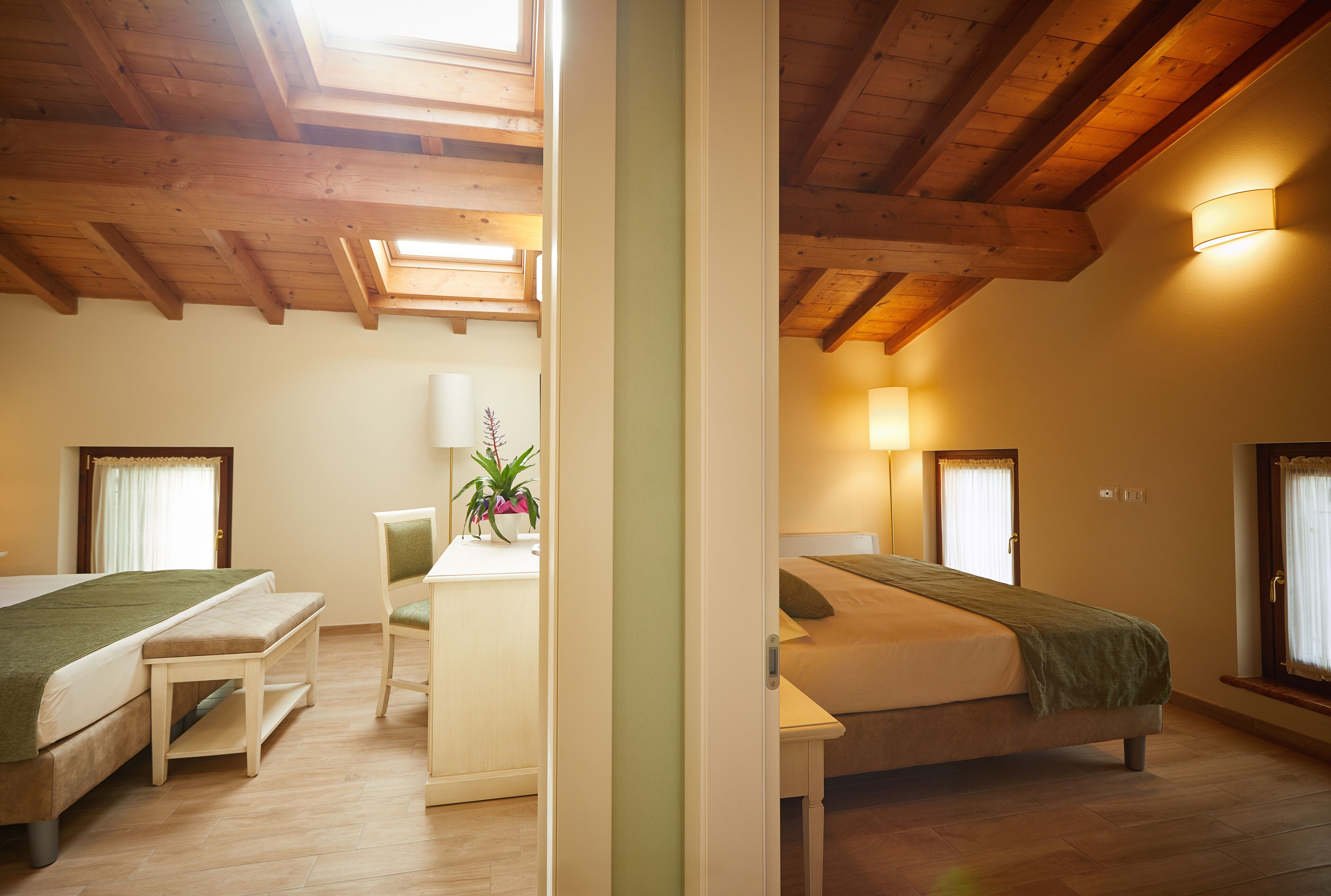 A room with two beds, a desk, and a chair.