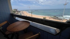 Ein Balkon mit Blick auf Strand und Meer.