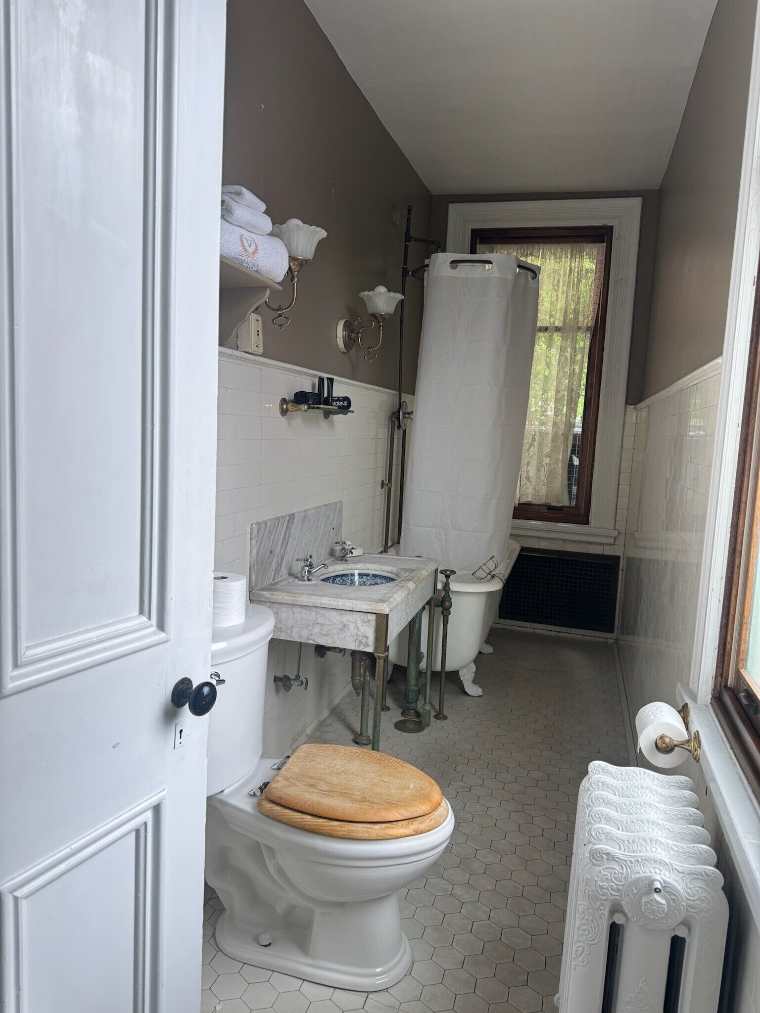 A bathroom with a toilet, sink, and shower area.