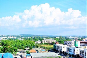 A cityscape with buildings, roads, and greenery.
