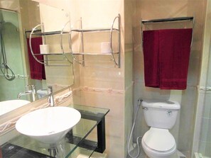 A bathroom with a glass sink, a white toilet, and a glass shower enclosure. - Spacious Studio View Talay 2 (Pattaya)
