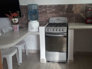 Fridge, microwave, coffee/tea maker, cookware/dishes/utensils